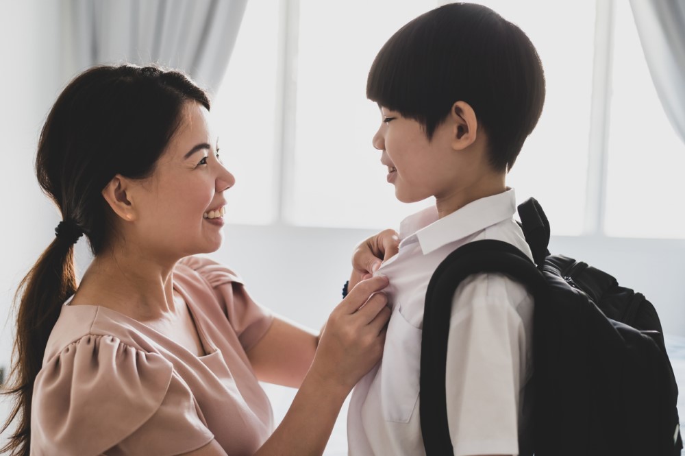 Mother is prepping her son to go to school